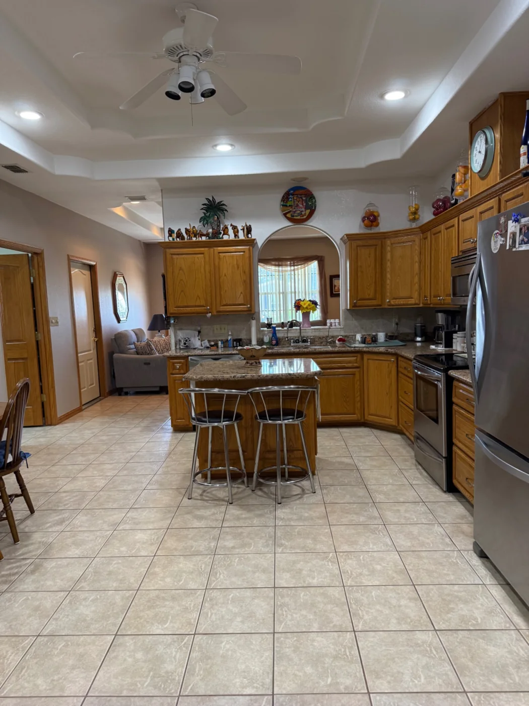 Kitchen island, wood cabinets and tile floors after a cleaning visit