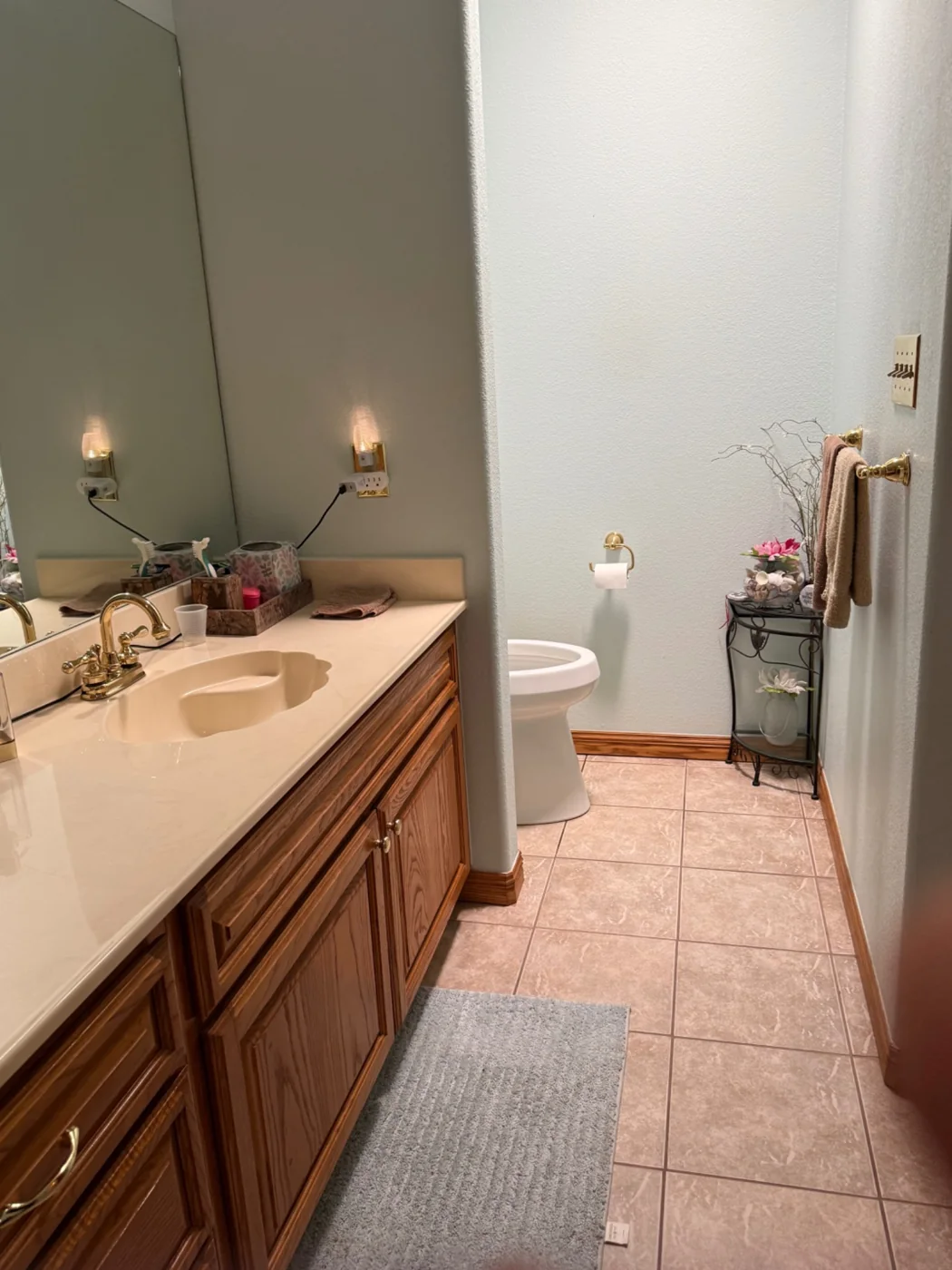 Bathroom vanity, sink, mirror and tiled floor after cleaning