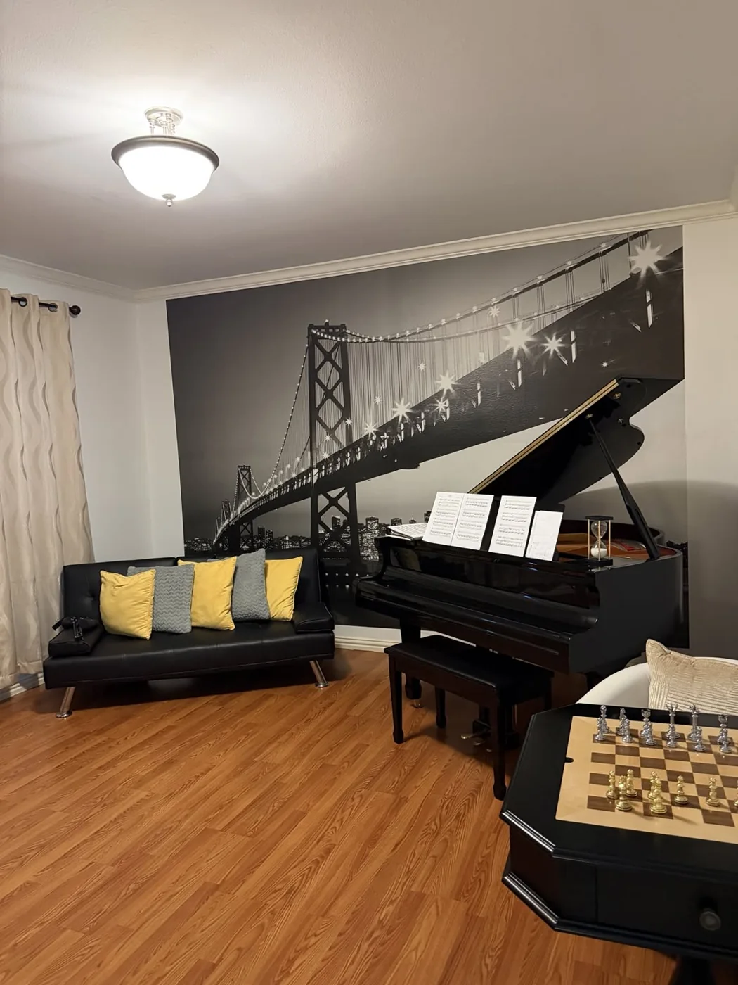 Piano and sitting room with wood floors
